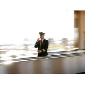 Pilot Walking on Moving Sidewalk on Cell Phone, Phoenix, Arizona, USA 