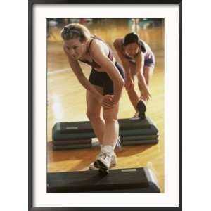 Two Young Women Exercising in a Step Aerobics Class Superstock 