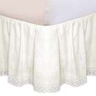 in cream top sheet styled in cream crib skirt has
