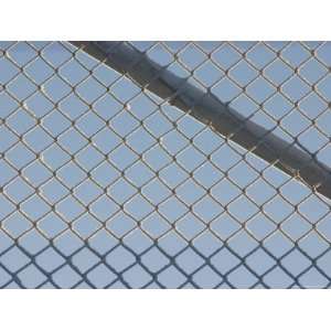  A Silver Metal Chain Link Fence Against Blue Sky Stretched 